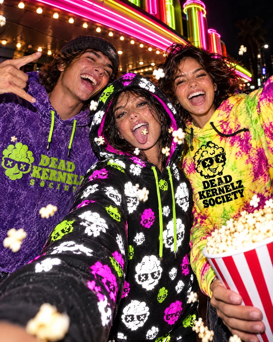 Friends in DKS hoodies taking a selfie at the movies (concept photo)